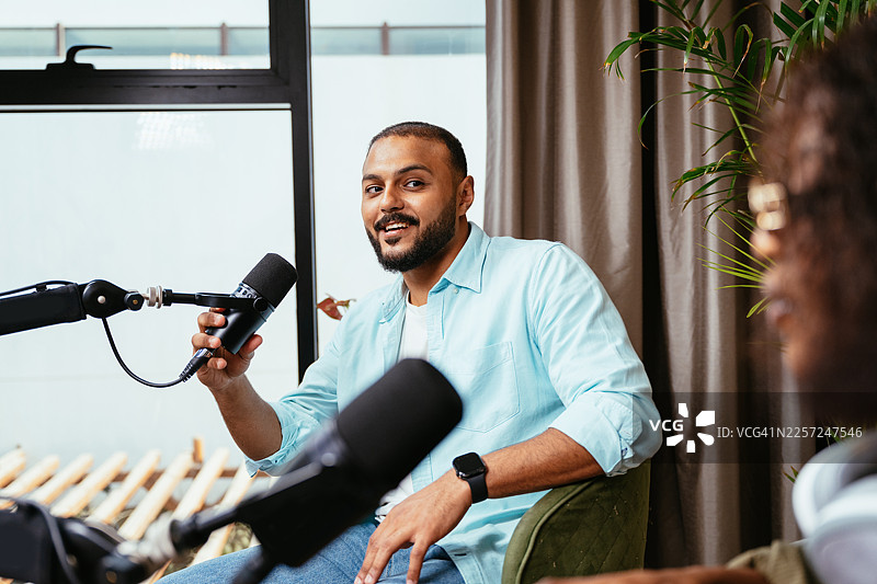 Z世代多元网红与博主在播客录音棚进行采访，讨论时事热点，并在社交媒体上直播图片素材