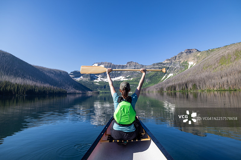 在加拿大落基山脉沃特顿湖国家公园卡梅伦湖上划独木舟的女子图片素材