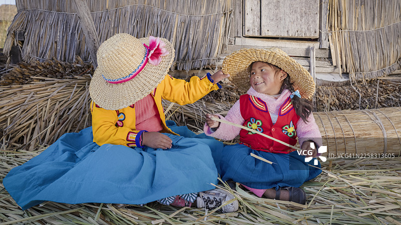 秘鲁的小女孩们生活在的的喀喀湖乌鲁斯浮岛上图片素材