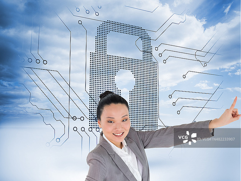 微笑的亚洲女商人指着的合成图像图片素材