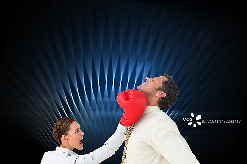 商务女性戴拳击手套击打男商人的合成图像图片素材