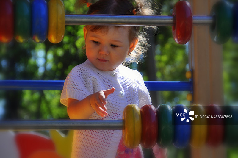 在操场玩彩色圆环的小女孩图片素材