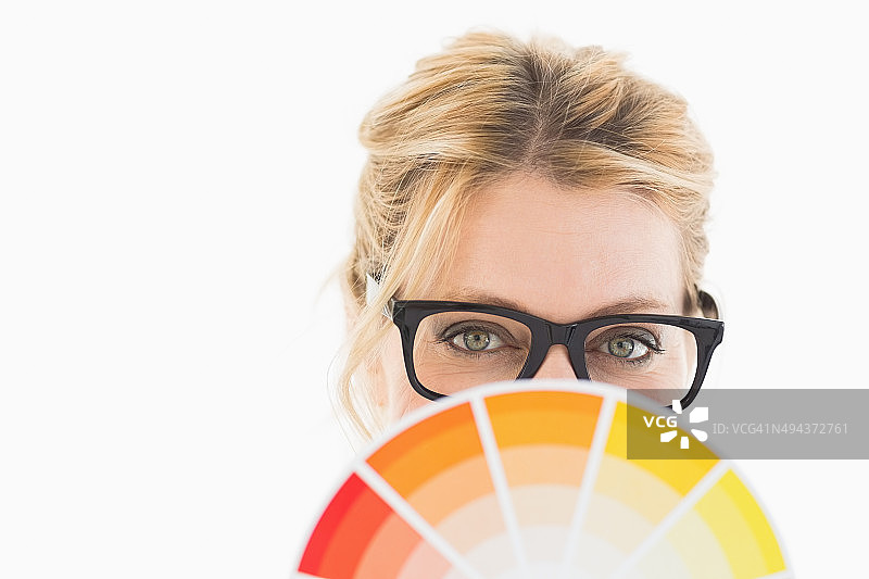 戴眼镜的金发女设计师拿着色轮图片素材