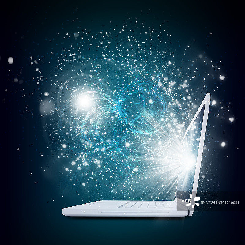 打开的笔记本电脑，带有神奇的光芒和坠落的星星图片素材