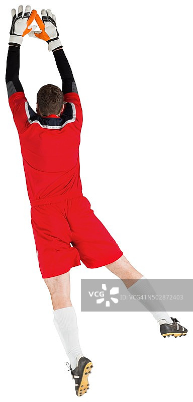 身穿红色球衣的守门员跳跃图片素材