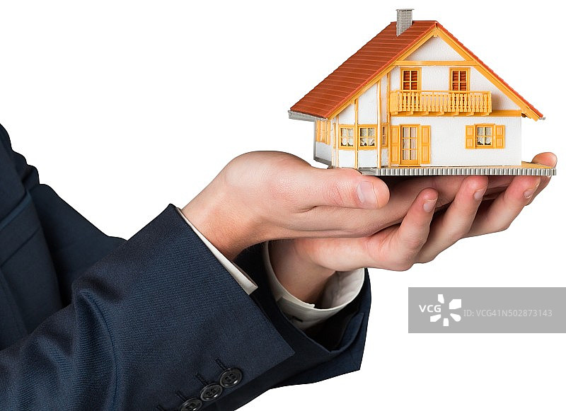 商人手持微型房屋模型图片素材
