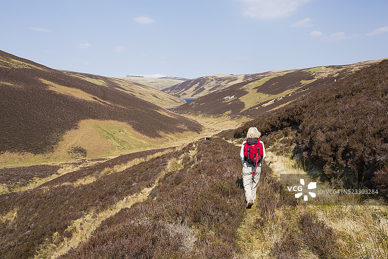 女人走向英国苏格兰南部高地的考吉尔上水库图片素材