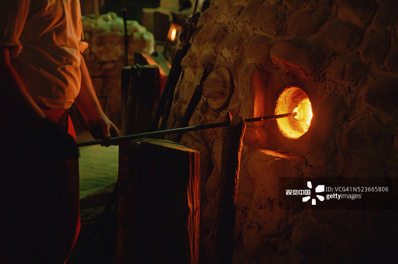 雕塑家在烤箱中拿着玻璃制品图片素材