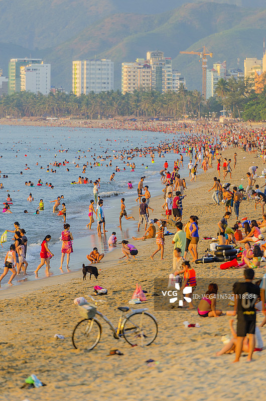 越南芽庄黎明时挤满越南游客的海滩图片素材