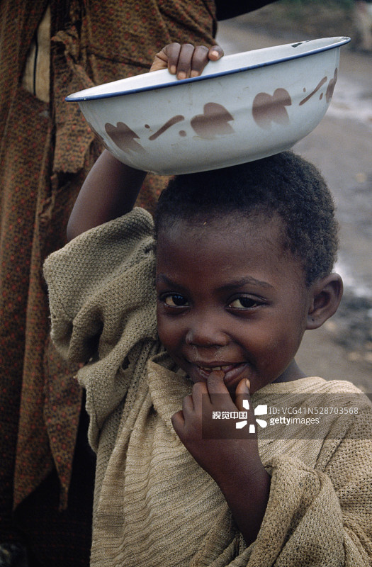 在坦桑尼亚尼亚古鲁苏难民营中端着碗的儿童图片素材