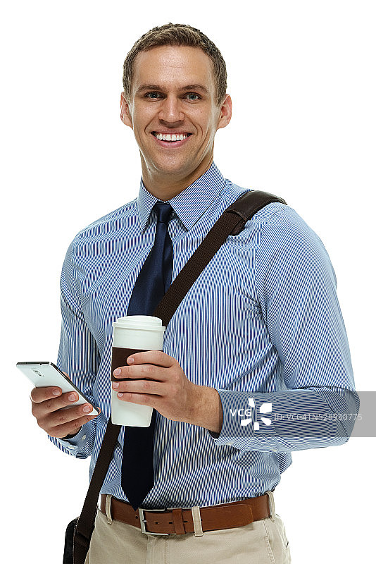 手持咖啡杯和手机的快乐商人图片素材