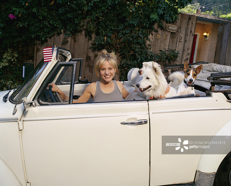 女演员杰莎琳·吉尔西格与狗狗在敞篷车里图片素材