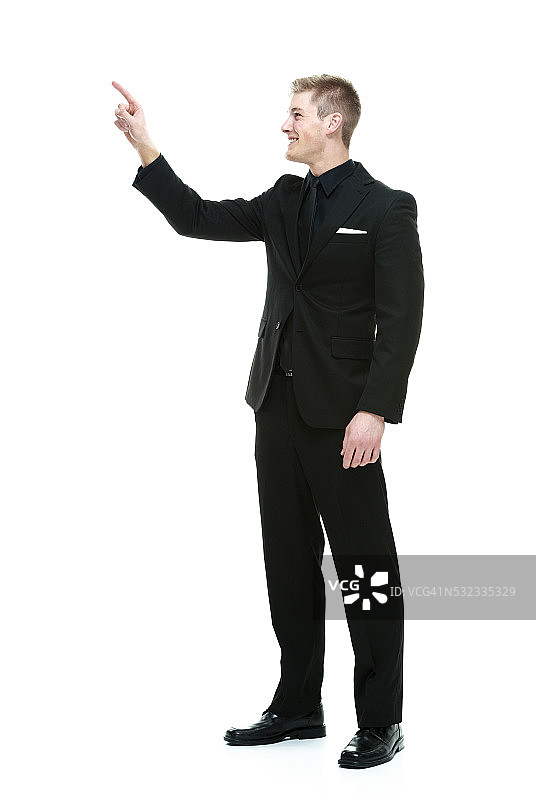 笑容灿烂的商人指向远方图片素材