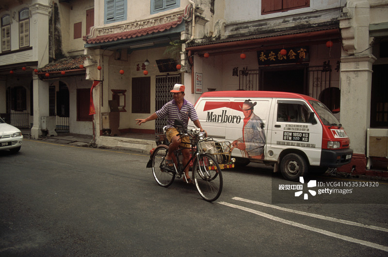 骑自行车者经过万宝路广告面包车图片素材