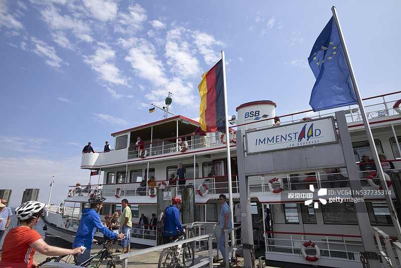 码头上的客运渡轮与骑自行车的人图片素材