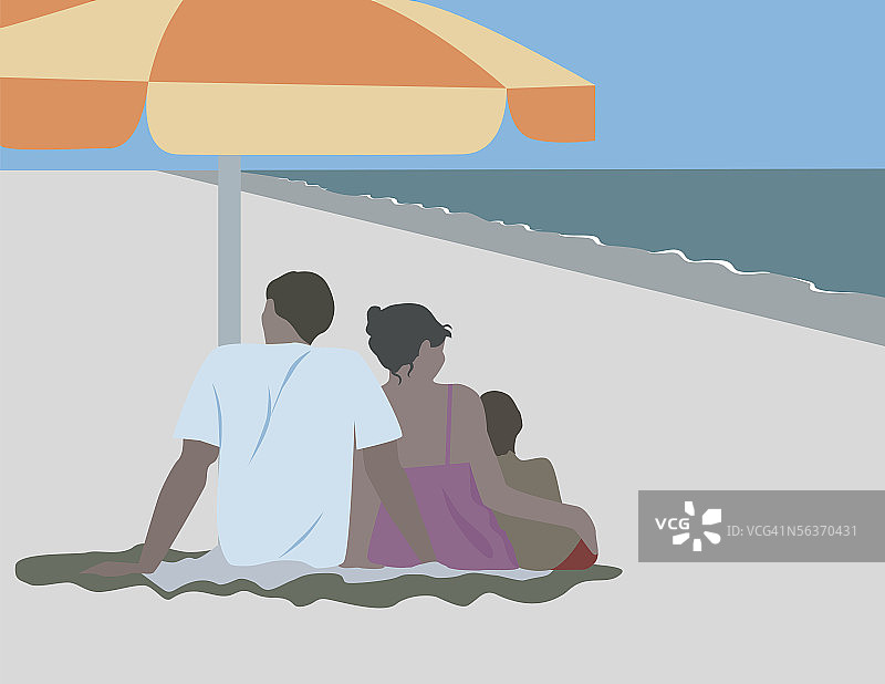 一家人在海滩的伞下放松图片素材