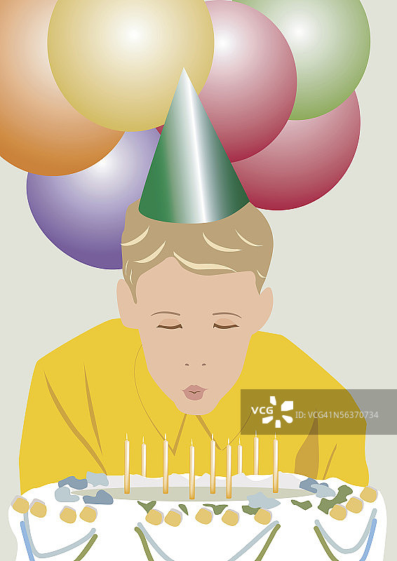 男孩吹灭生日蛋糕上的蜡烛图片素材