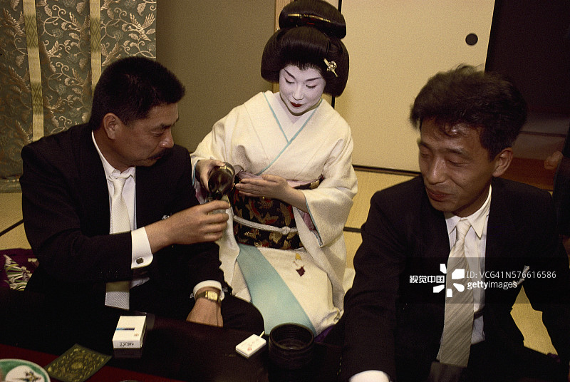艺伎为商人斟酒图片素材