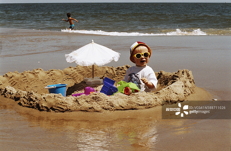 在沙滩上玩耍的小男孩图片素材