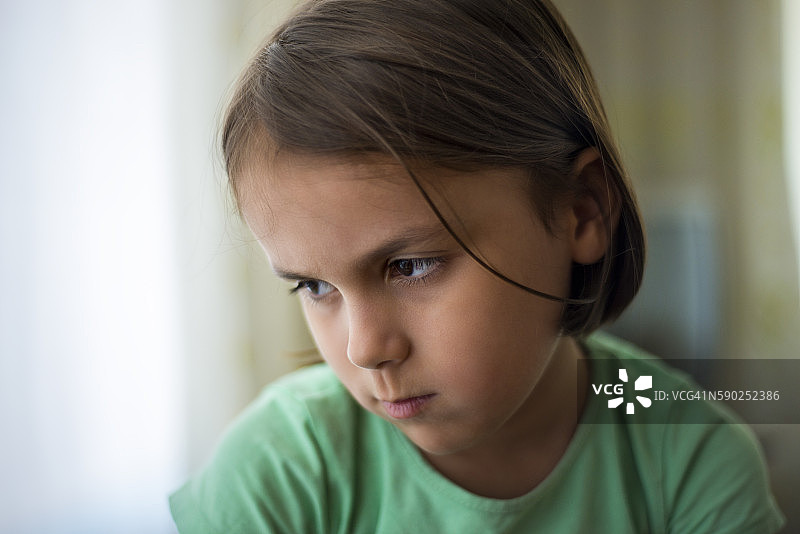 望着窗外，面带悲伤的女孩肖像图片素材