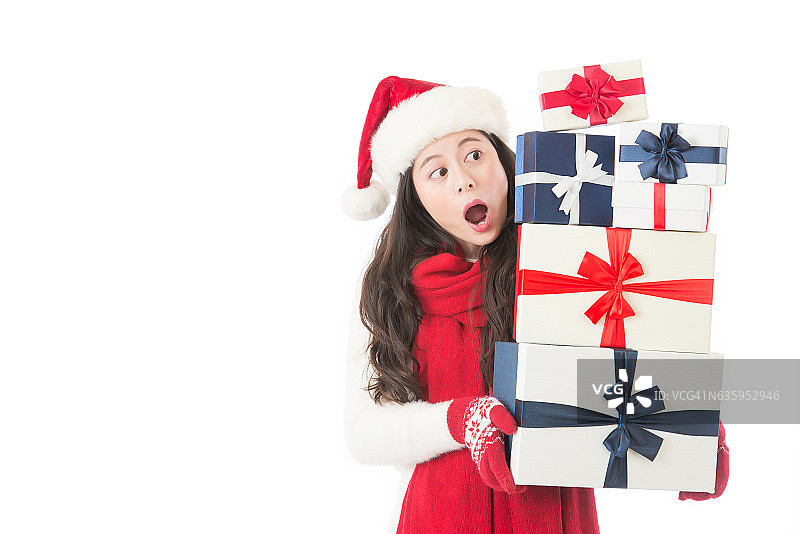 惊喜地看着许多礼物的快乐圣诞女人图片素材