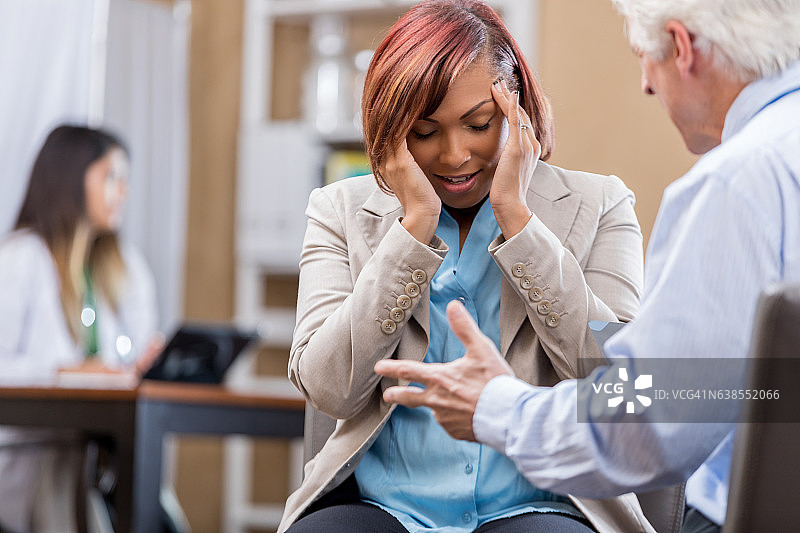 患有偏头痛的非裔美国妇女与医生交谈图片素材