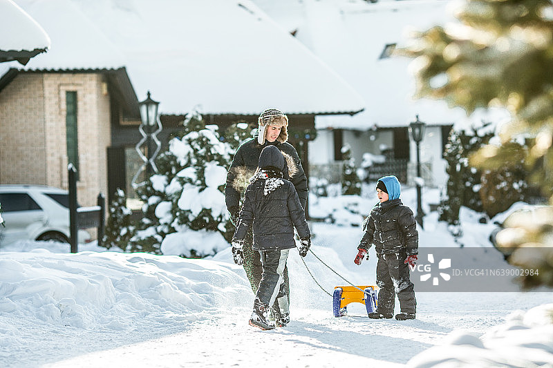 一家人在雪地里玩滑梯图片素材