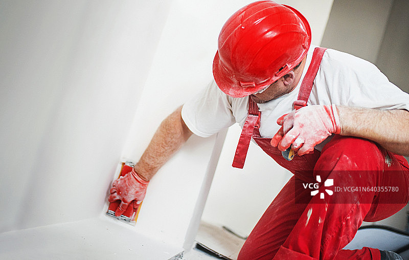 建筑工人打磨石膏板表面图片素材