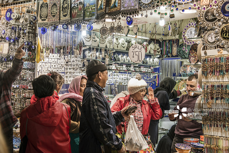 在土耳其伊斯坦布尔大巴扎讨价还价的远东游客图片素材