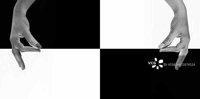 手指在黑白之间拉出一条想象的线图片素材