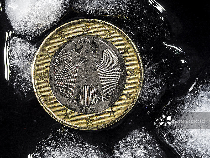 德国欧元货币在冰块之间，欧元区货币危机概念图片素材