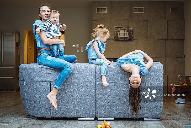 妈妈，两个女儿和一个小儿子在沙发上图片素材