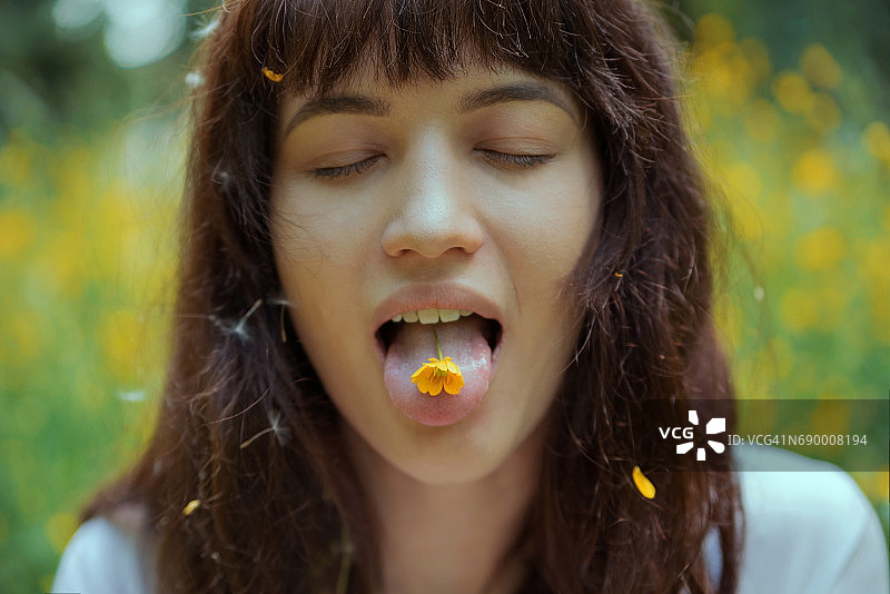 吐舌头，脸上带着花的女孩图片素材