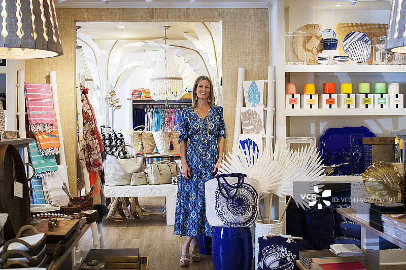 在她时尚精品店里的中年女店主肖像图片素材