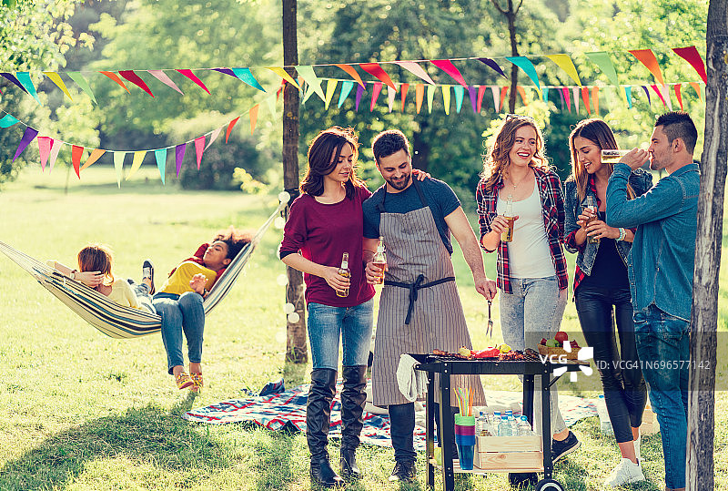 朋友们在公园里野餐和烧烤图片素材