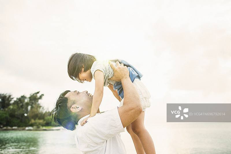 父亲和女儿在海滩上玩耍图片素材