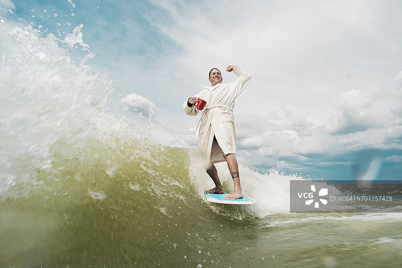 男子穿着浴袍冲浪图片素材