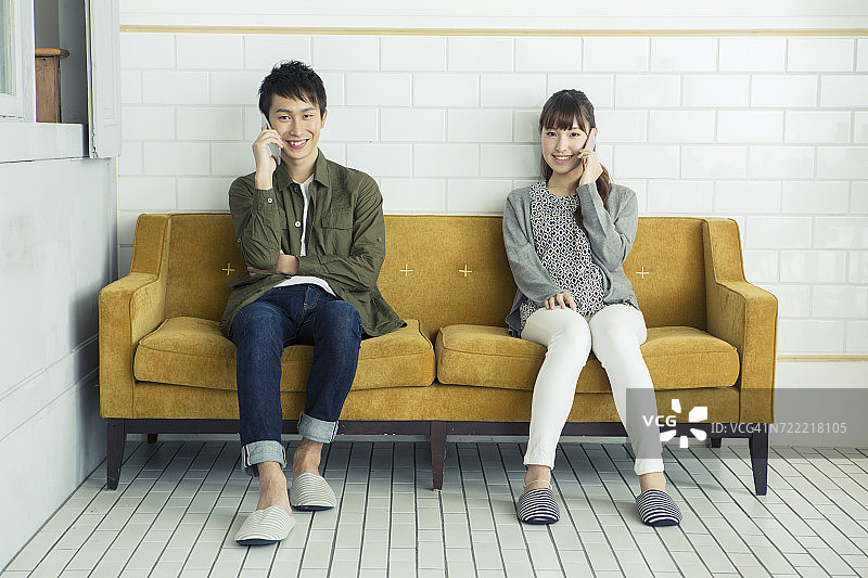 年轻男女在智能手机上交谈图片素材