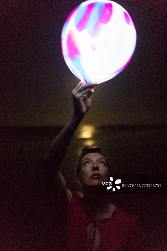 中年妇女在哥斯达黎加瓜纳卡斯特省诺萨拉海滩上拿着发光的气球图片素材