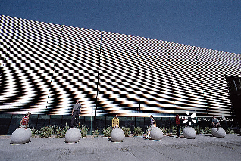 在建筑物外摆姿势的商务人士图片素材