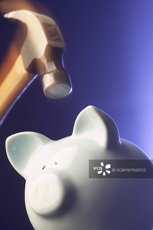 锤子砸碎白色陶瓷储蓄罐图片素材