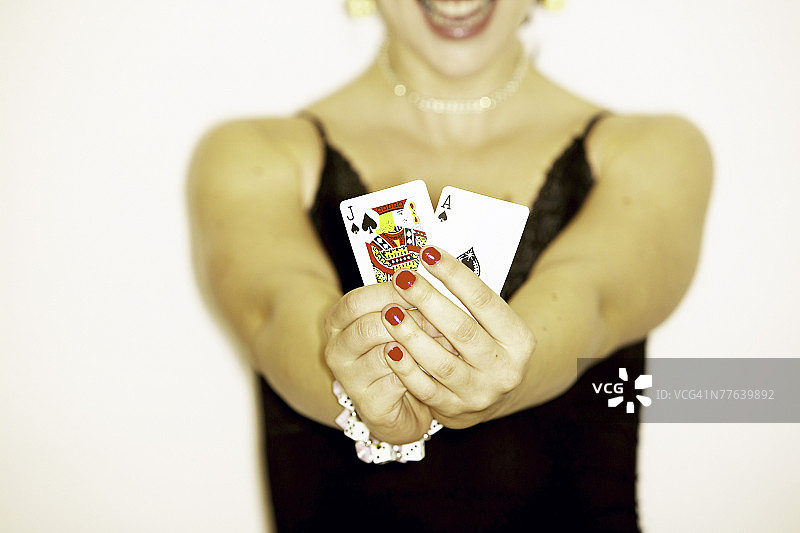 女人手持黑桃J和A图片素材