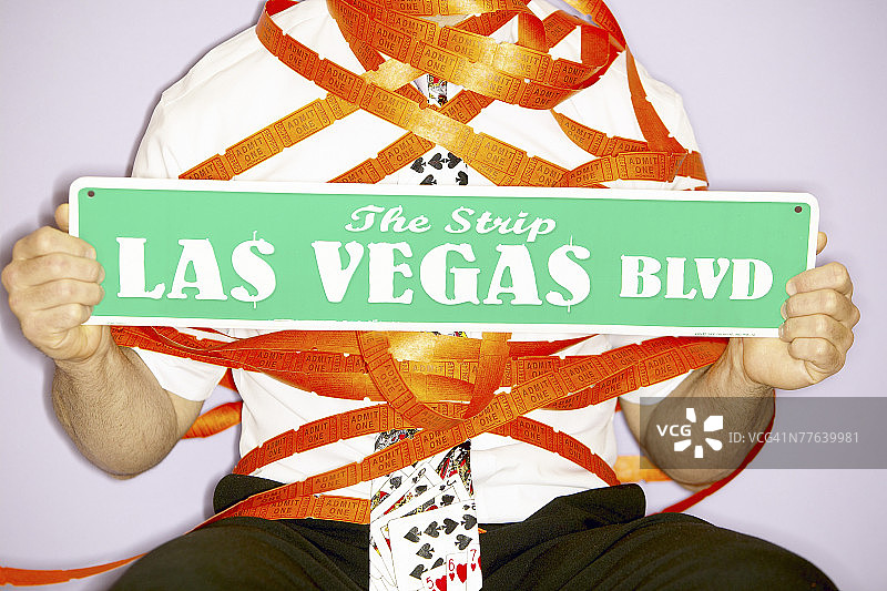 拿着写有拉斯维加斯大道字样的路标的人图片素材