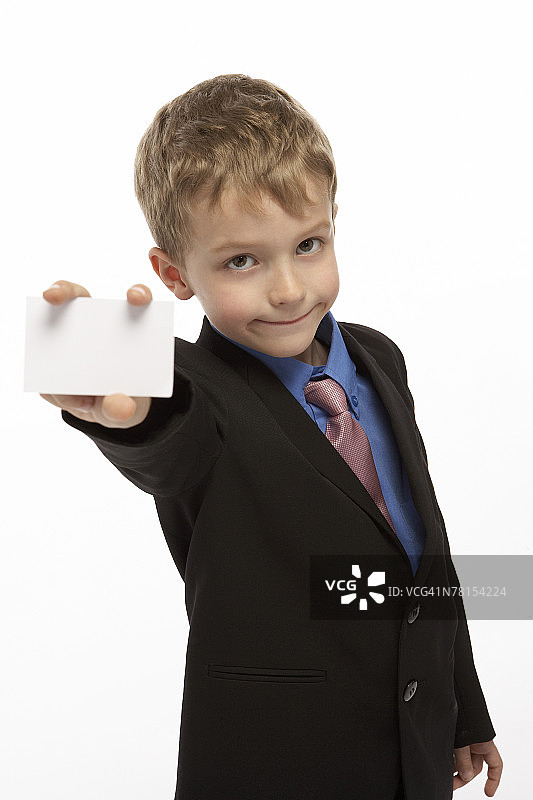 打扮成商人模样的小男孩拿着名片图片素材