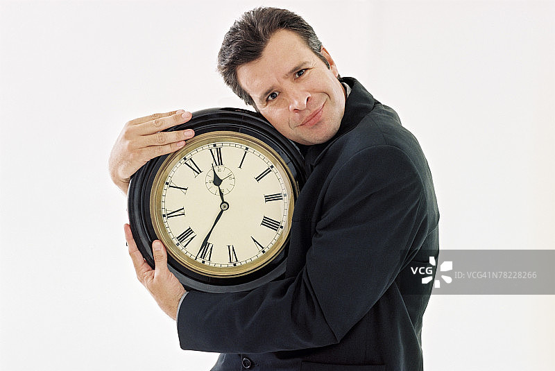 拿着时钟的男人图片素材