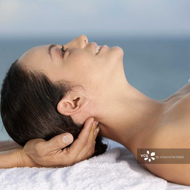 年轻女人接受颈部按摩的特写镜头图片素材