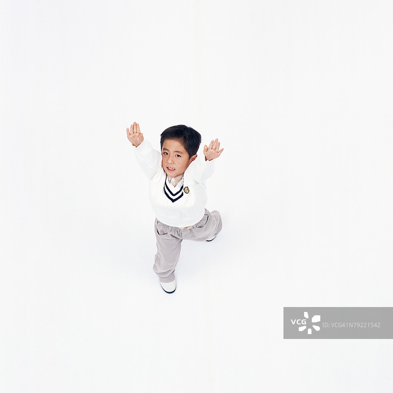 小男孩高举双手的俯视图图片素材