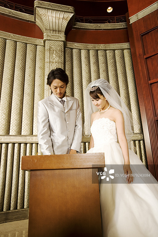 新娘和新郎在书上签字图片素材