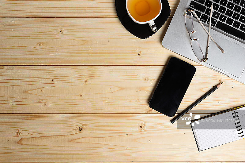 智能手机、绿茶杯、笔记本电脑和办公用品俯视图图片素材