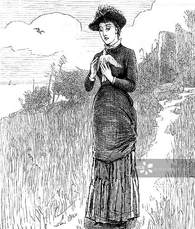 女人在小路上行走，手中拿着鸽子图片素材